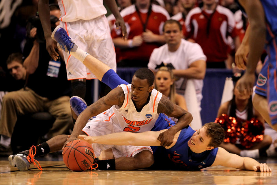 PHOENIX, AZ - MARCH 24: Russ Smith #2 of the Louisville Cardinals and Erik Murphy #33 of the Florida Gators battle for a loose ball in the second half during the 2012 NCAA Men's Basketball West Regional Final at US Airways Center on March 24, 2012 in Phoenix, Arizona. (Photo by Jamie Squire/Getty Images)