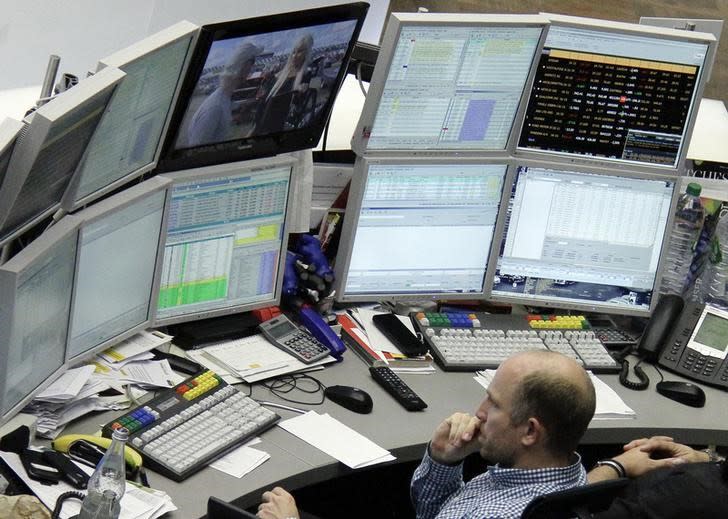 A trader sits at his desk at the Frankfurt stock exchange October 16, 2014. REUTERS/Stringer/Files