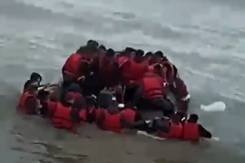 Screengrab from a video found on Cunaj's phone showing a large number of migrants wearing life jackets on a boat at sea