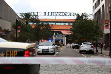 Police officers cordon off a street outside The Jacksonville Landing after a shooting during a video game tournament in Jacksonville, Florida August 26, 2018. REUTERS/Joey Roulette