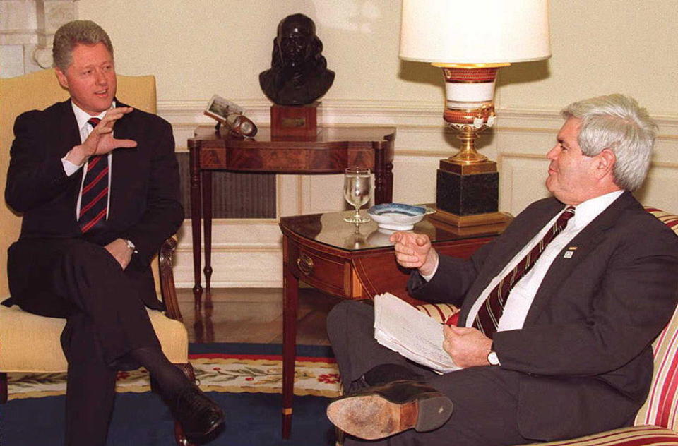 President Bill Clinton speaks to House Speaker Newt Gingrich during a budget meeting at the White House on Dec. 19, 1995. / Credit: RICHARD ELLIS/AFP via Getty Images