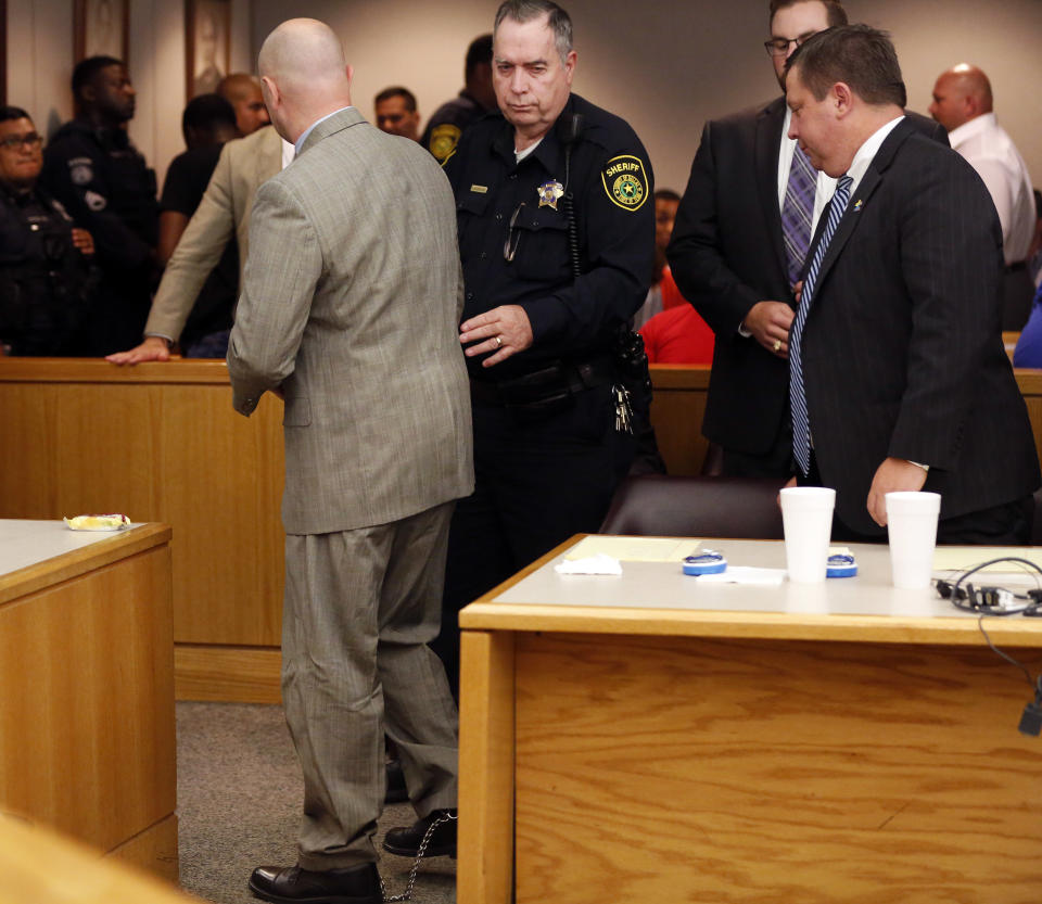 Former Balch Springs Police Officer Roy Oliver, left, is led out by the bailiff after being sentenced to 15 years in prison for the murder of 15-year-old Jordan Edwards, Wednesday, Aug. 29, 2018, at the Frank Crowley Courts Building, in Dallas. (Rose Baca/The Dallas Morning News via AP, Pool)