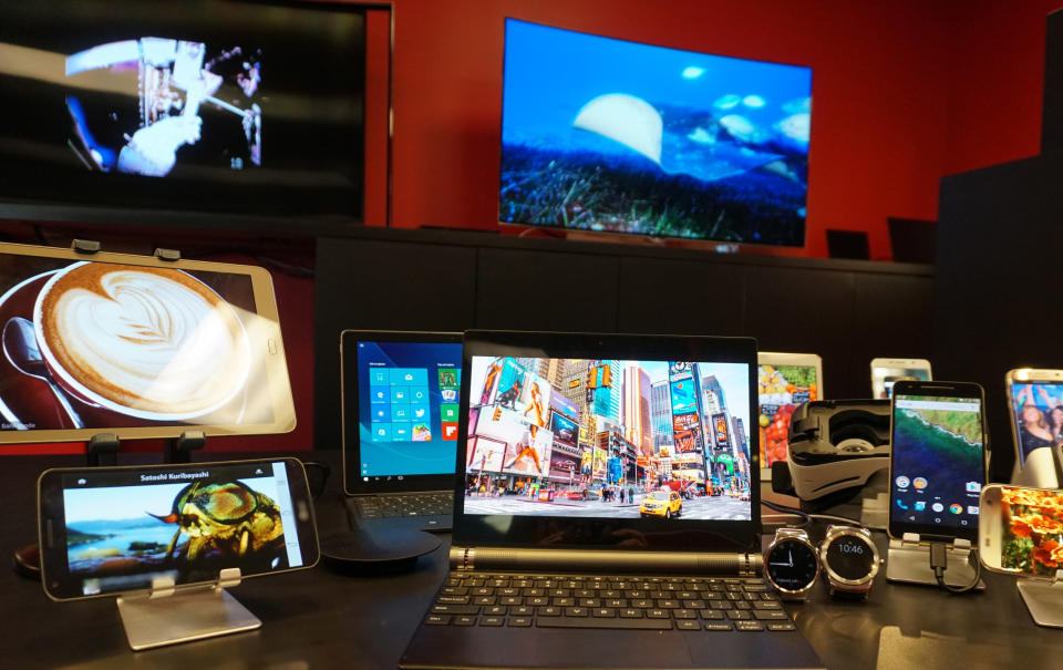 Various devices with OLED displays: laptops, tablets, TVs, smartphones, and smart watches.
