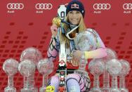 FILE - In this March 13, 2010, file photo, Lindsey Vonn, of the United States, poses in Garmisch-Partenkirchen, Germany, with all the Olympic medals and Women's World Cup trophies she won in her career. Vonn announced Friday, Feb. 1, 2019, that she will retire from ski racing after this month's world championships in Sweden. (AP Photo/Giovanni Auletta, File)