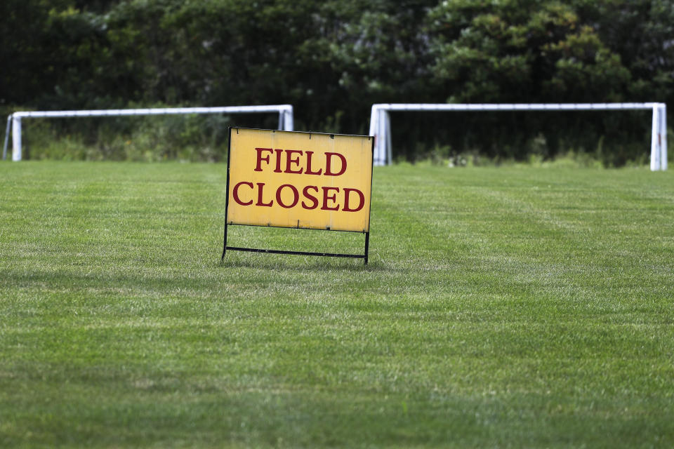 A sign announces that the field is closed at Vernon Hills Athletic Complex in Vernon Hills, Ill., Thursday, July 30, 2020. Governor J.B Pritzker introduced new restrictions for recreational sports leagues in Illinois Wednesday, as the number of coronavirus cases continues to rise across the state. (AP Photo/Nam Y. Huh)