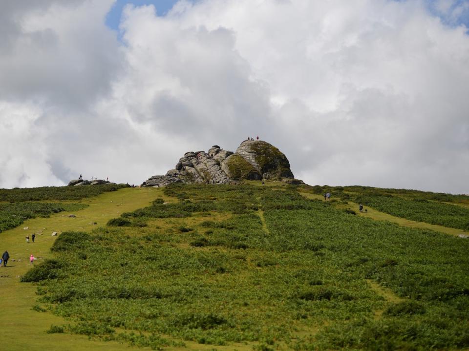 The 22-year-old was watching the sunset at Haytor Rocks (pictured) when he suffered a cardiac arrest (Ben Stansall/AFP via Getty Images)