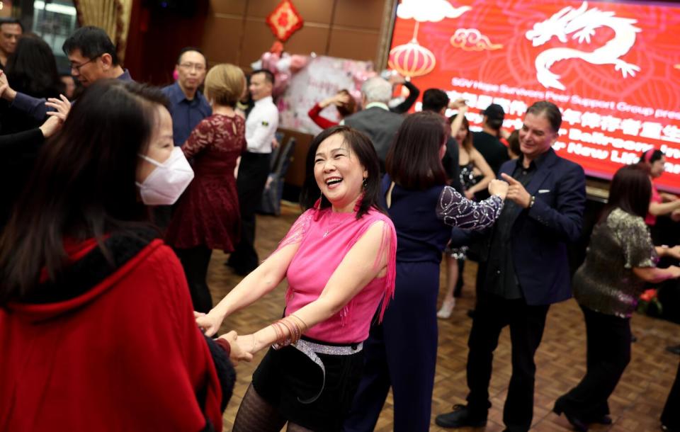 People dance in a ballroom.