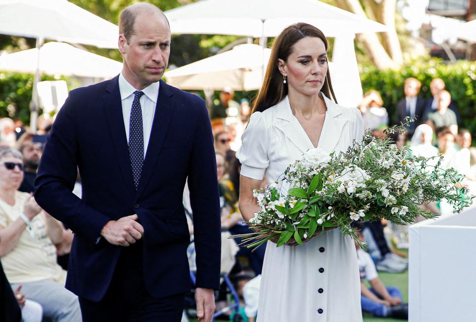 Britain's Prince William, Duke of Cambridge (L) and Britain's Catherine, Duchess of Cambridge (C) lay a wreath at a memorial service at the foot of Grenfell Tower in London, on June 14, 2022, the fifth anniversary of the Grenfell Tower fire where 72 people lost their lives. - The names of the 72 people who perished in Britain's worst residential fire since World War II were read out on June 14, 2022 at a church service marking the fifth anniversary of the blaze. Survivors and families of the victims of the Grenfell Tower fire gathered at Westminster Abbey for the first of a day of events to remember the tragedy. (Photo by PETER NICHOLLS / POOL / AFP) (Photo by PETER NICHOLLS/POOL/AFP via Getty Images)