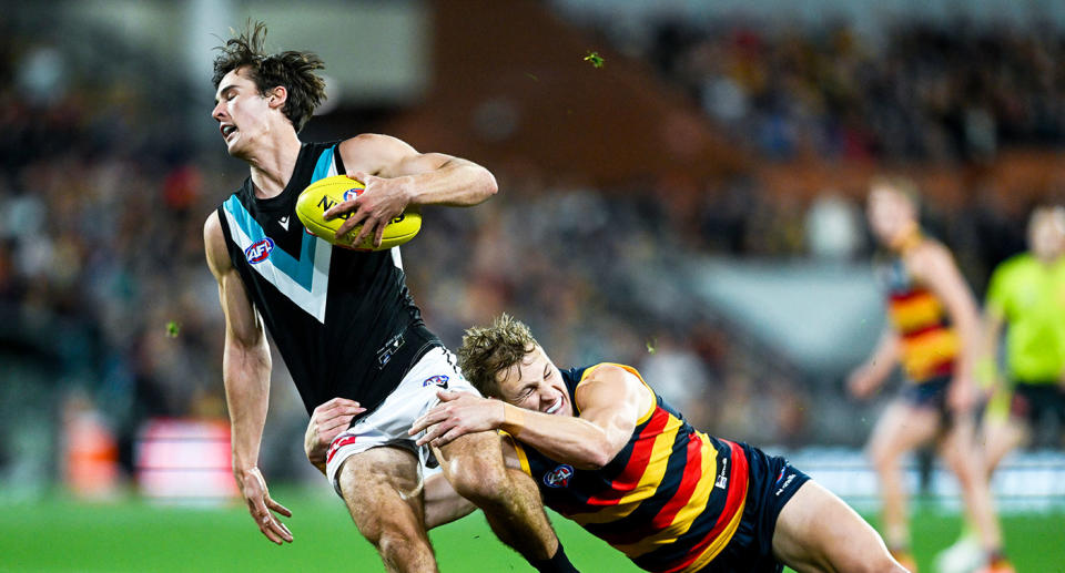Seen here, Port Adelaide captain Connor Rozee is tackled during his side's loss to city rivals the Crows.