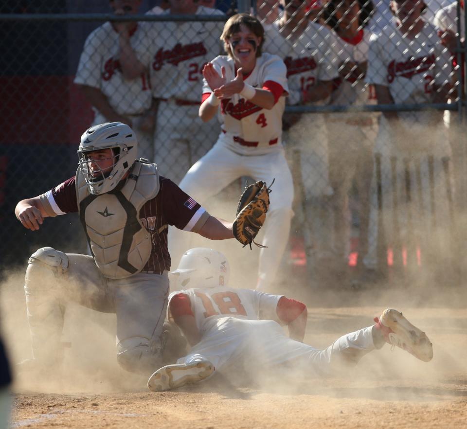 Roy C. Ketcham's Kevin Camacho attempts to steal home plate under Arlington's Joe Ruppert during Wednesday's game on May 17, 2023. 