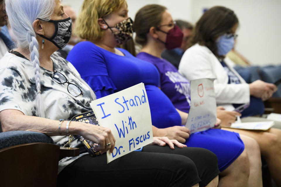 Vaccine advocates sit in on a state legislative committee meeting, Wednesday, July 21, 2021, in Nashville, Tenn. Being discussed was the Department of Health vaccine administration following the firing of Dr. Michelle Fiscus, the state's top vaccine official, after state lawmakers complained about efforts to promote COVID-19 vaccination among teenagers. (AP Photo/John Amis)