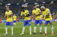 Brazil's Vinicius Junior, 2nd left, celebrates after scoring his side's opening goal during the World Cup round of 16 soccer match between Brazil and South Korea at the Stadium 974 in Doha, Qatar, Monday, Dec. 5, 2022. Left to right, Raphinha, Vinicius Junior, Lucas Paqueta, Neymar. (AP Photo/Jin-Man Lee)