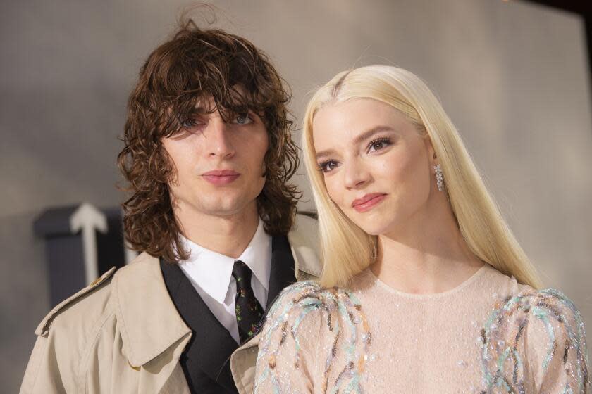 Malcolm McRae and Anya Taylor Joy lean their heads together when arriving for a movie premiere in London