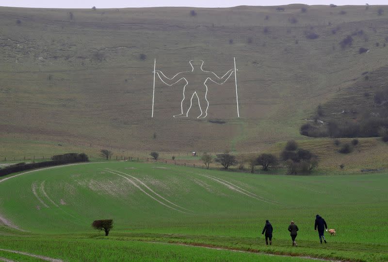 Long Man of Wilmington hill figure restored, following an alteration depicting a mask, in South Downs national park, near Eastbourne