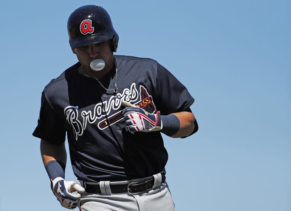 Atlanta Braves' Austin Riley (74) blows a bubble as he heads into the dugout during an exhibition spring training baseball game against the Miami Marlins on Wednesday, March 6, 2019, in Jupiter, Fla. (AP Photo/Brynn Anderson)