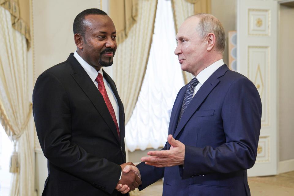 Vladimir Putin, right, today shook hands with Ethiopian prime minister Abiy Ahmed during their meeting on the eve of the Russia Africa Summit in St Petersburg (AP)