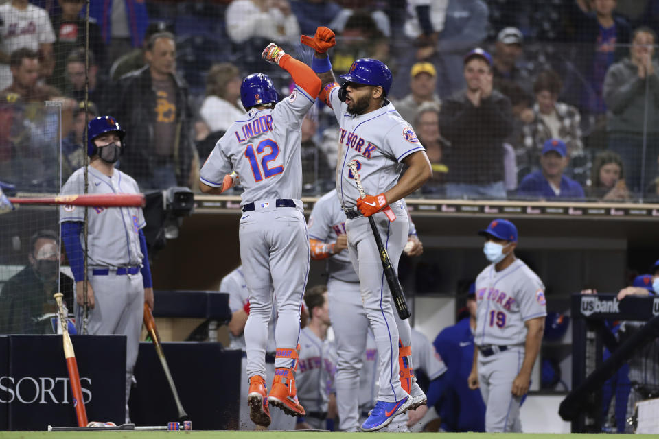New York Mets' Francisco Lindor (12) celebrates with Dominic Smith, right, after hitting a solo home run off San Diego Padres starting pitcher Joe Musgrove during the fifth inning of a baseball game Saturday, June 5, 2021, in San Diego. (AP Photo/Derrick Tuskan)