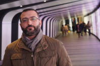 Mazen Masri, an academic and a consultant to the legal team suing the NSO Group in Israel over alleged abuses involving its spyware, poses for a photograph in a pedestrian underpass leading to King's Cross Station in London on Monday, Jan. 27, 2019. He is among half a dozen people who have been approached by undercover operatives on false pretexts over the past two months. All six have crossed paths with the NSO Group in some way. (AP Photo/Raphael Satter)