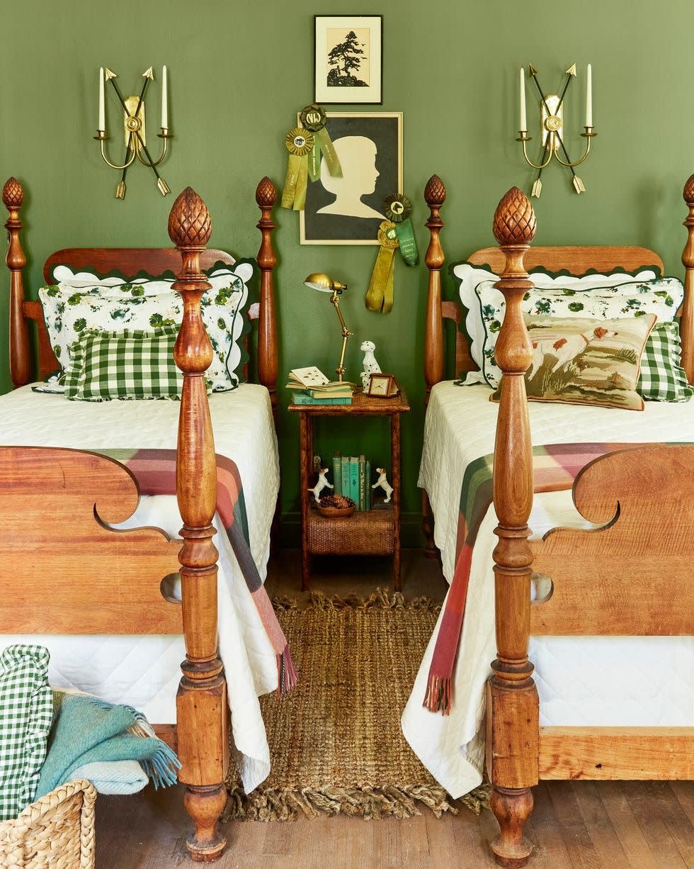 green bedroom with two wood twin beds