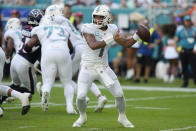 Miami Dolphins quarterback Tua Tagovailoa (1) aims a pass during the first half of an NFL football game against the Houston Texans, Sunday, Nov. 27, 2022, in Miami Gardens, Fla. (AP Photo/Lynne Sladky)