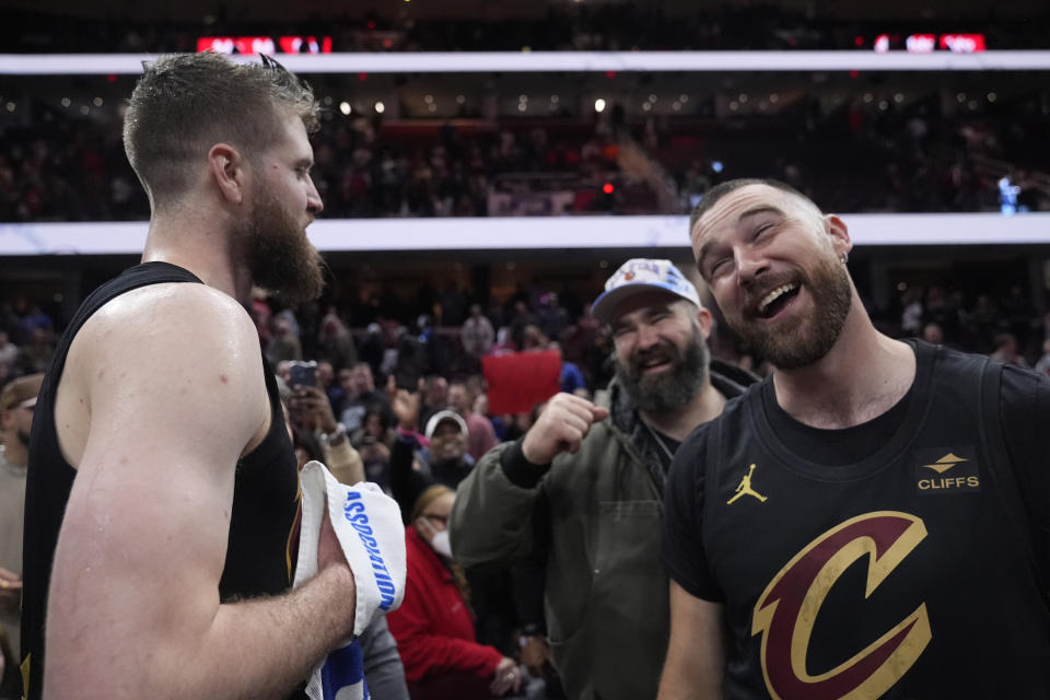 Cleveland Cavaliers forward Dean Wade, left, celebrates with Jason Kelce, center, and Travis Kelce, right, after the Cavaliers defeated the Boston Celtics in an NBA basketball game, Tuesday, March 5, 2024, in Cleveland. (AP Photo/Sue Ogrocki)