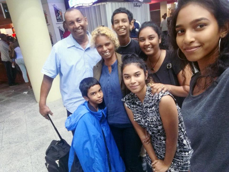 <p>Lynda Mahabir (second left) had hoped it would be a matter of months before her family would be able to join her when she left for the UK in October 2018 – but they are still apart</p> (Lynda Mahabir)