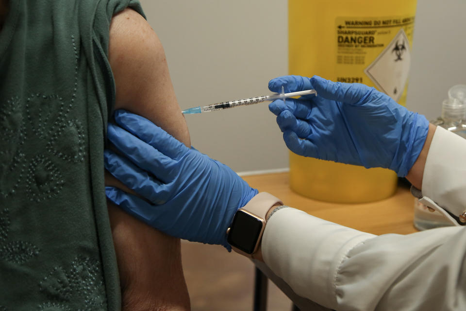 A NHS vaccinator, administers the Pfizer/BioNTech Covid-19 booster vaccine to a woman at a vaccination centre. (Photo by Dinendra Haria / SOPA Images/Sipa USA)