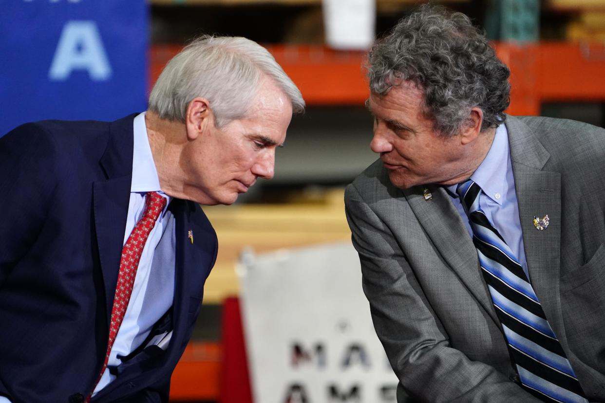 Sens. Rob Portman, left, and Sherrod Brown attend an event with President Joe Biden at United Performance Metals in Hamilton in May.