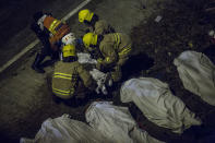 <p>Emergency services workers (C) prepare to carry a body of a passenger after a bus crash in Hong Kong on Feb. 10, 2018. (Photo: Isaac Lawrence/AFP/Getty Images) </p>