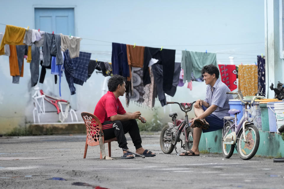 Refugees talk outside a hotel turned into a shelter for refugees in Bintan, an island in northwestern Indonesia, Thursday, May 16, 2024. (AP Photo/Dita Alangkara)