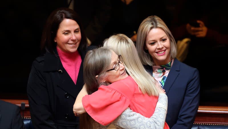 Senate Majority Whip Ann Millner, R-Ogden, hugs Emily Bell, Utah Period Project founder and president, as Mary Catherine Perry, Utah Period Project director of policies and government affairs, and Kristin Andrus, Utah Period Project community champion, stand behind them in the Senate chamber at the Capitol in Salt Lake City after the Senate voted 24-0 to require Utah public schools to stock free period products in all female or unisex restrooms in elementary, middle and high schools on Thursday, Feb. 10, 2022.