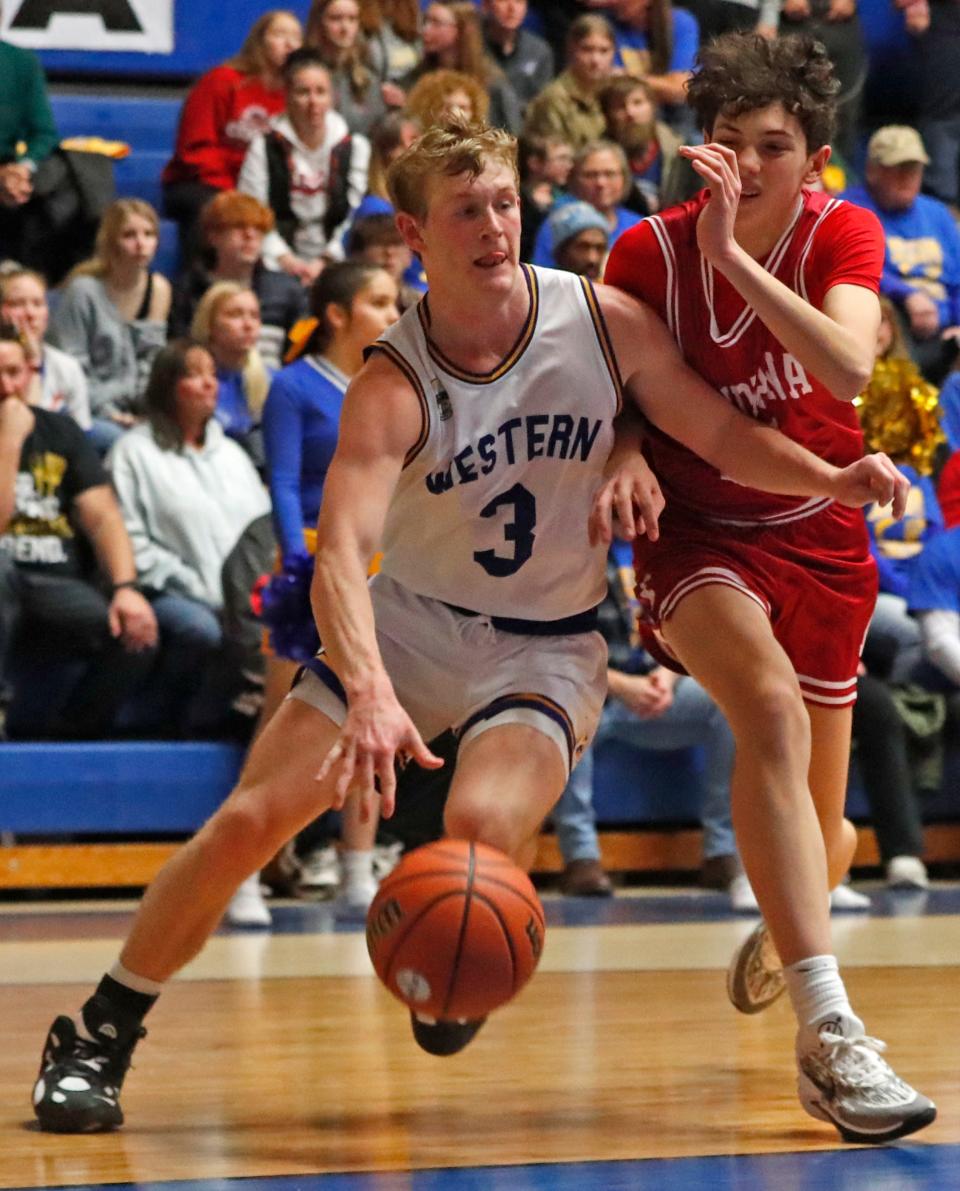 Frankfort Hot Dogs Kye Kirby (3) drives past Rossville Hornets Brayden Thiele-Hahn (5) during the IHSAA boy’s basketball game celebrating the 30th anniversary of the film “Blue Chips”, Saturday, Jan. 13, 2024, at Case Arena in Frankfort, Ind.