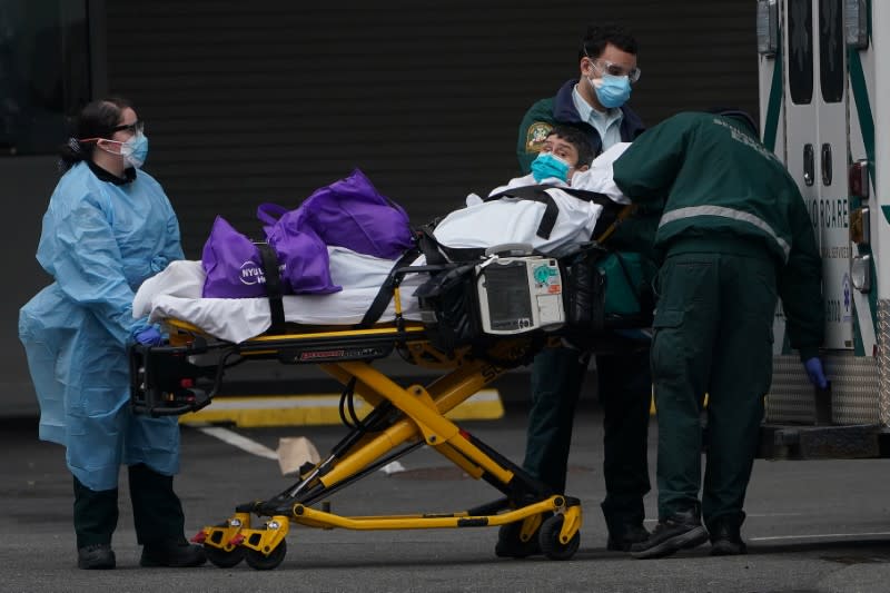 Paramedics move a patient into the hospital during the outbreak of coronavirus disease (COVID-19), in the Manhattan borough of New York City