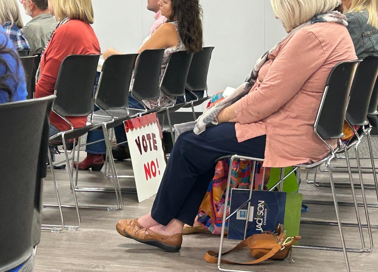 An attendee in opposition to the establishment of an ACE charter school in Jackson sits during the Tennessee Public Charter Commission's appeal hearing on September 18, 2023 in Jackson, TN.