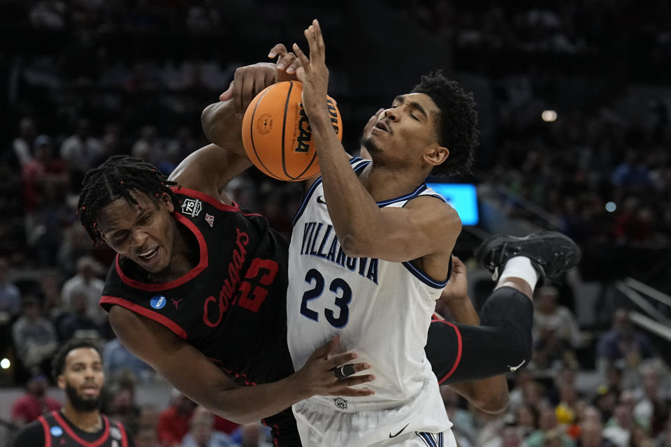 Villanova forward Jermaine Samuels is fouled by Houston center Josh Carlton during the first half of a college basketball game in the Elite Eight round of the NCAA tournament on Saturday, March 26, 2022, in San Antonio. (AP Photo/Eric Gay)