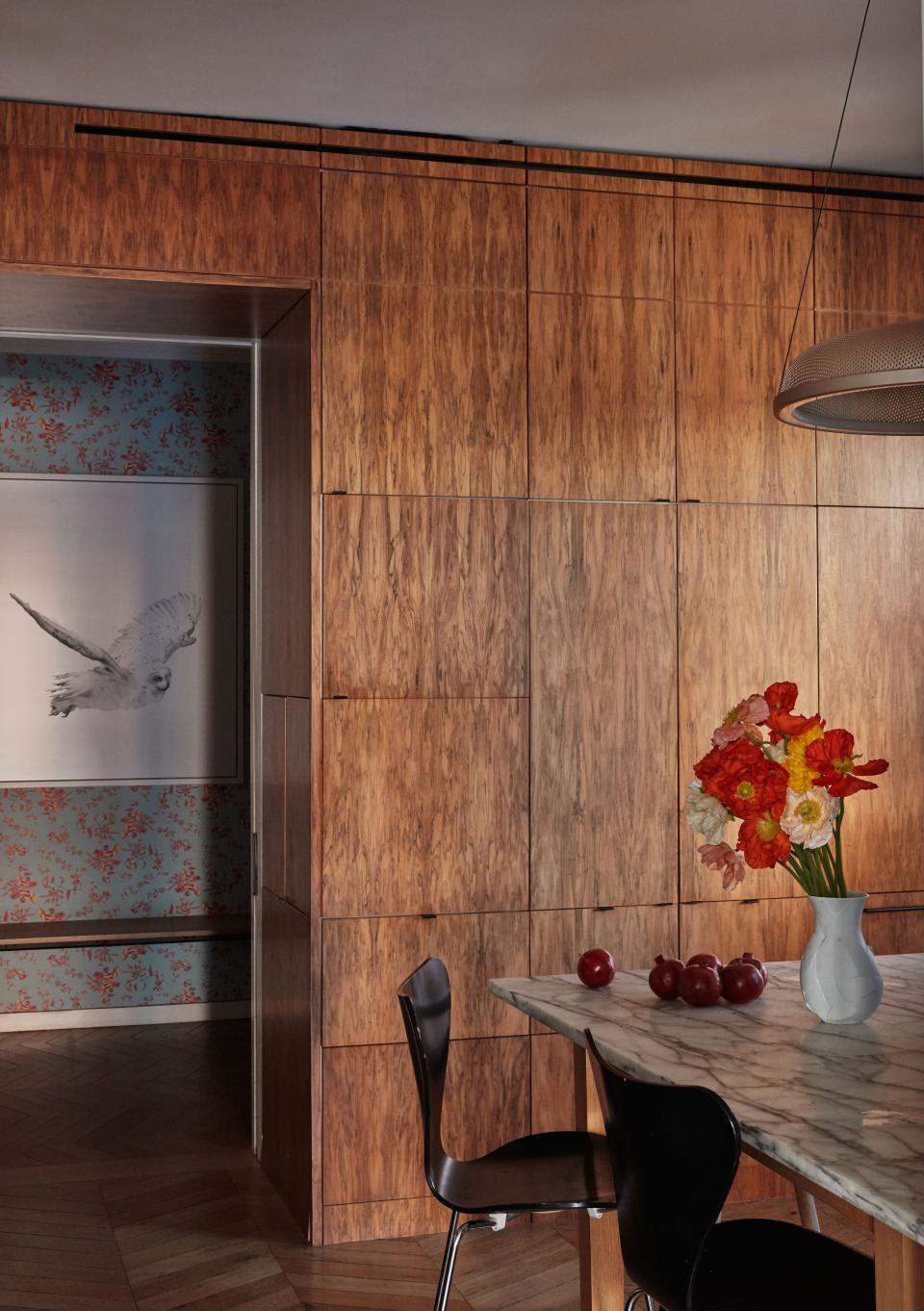 The wood-paneled kitchen, with a view of a Zuckerman photograph and Superflower’s Cannonball wallpaper beyond.