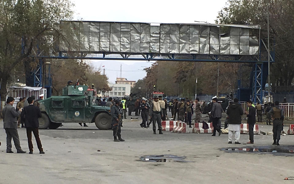 Security forces inspect the site of a suicide attack in the capital of Kabul, Afghanistan, Monday, Nov. 12, 2018. Afghan officials confirm at least three people killed in a blast happened near a high school and the Kabul municipality office while hundreds of people gather to protest against Taliban attacks in Jaghuri and Malistan districts of eastern Ghazni province. (AP Photo/Massoud Hossaini)