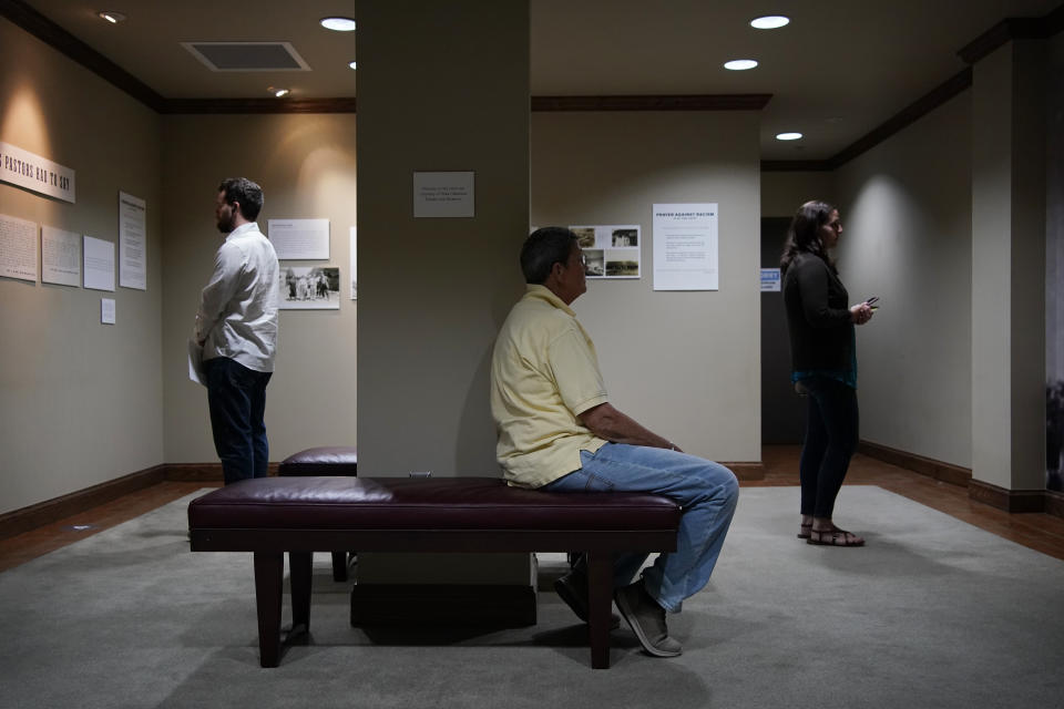 People site and contemplate in a prayer room dedicated to the Tulsa Race Massacre at the First Baptist Tulsa church during centennial commemorations, Sunday, May 30, 2021, in Tulsa, Okla. The church made the room to provide a place to explore the history of the Tulsa Race Massacre of 1921 and to prayerfully oppose racism. (AP Photo/John Locher)