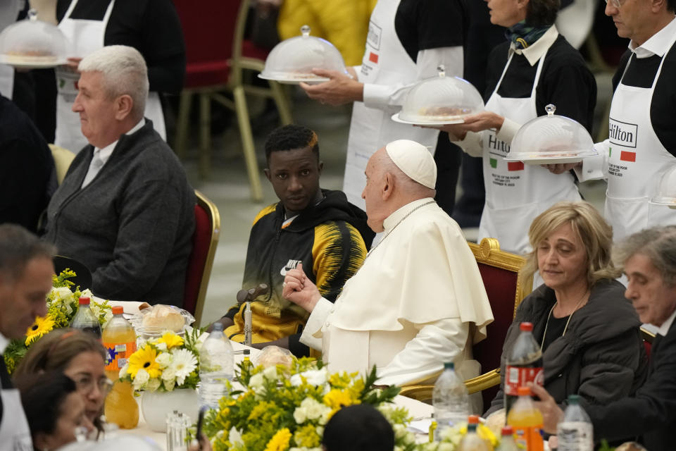 Pope Francis sits at a table during a lunch, in the Paul VI Hall at the Vatican, Sunday, Nov. 19, 2023. Pope Francis offered several hundred poor people, homeless, migrants, unemployed a lunch on Sunday as he celebrates the World Day of the Poor with a concrete gesture of charity in the spirit of his namesake, St. Francis of Assisi. (AP Photo/Andrew Medichini)