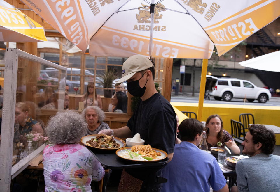 Food is served to guests at a restaurant in Manhattan, after New York City Mayor Bill de Blasio announced that proof of coronavirus disease (COVID-19) vaccination will be required for customers and staff at restaurants, gyms and other indoor businesses, in New York City, U.S., August 3, 2021. REUTERS/Caitlin Ochs