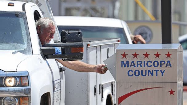 PHOTO: A voter places a ballot in a drop box outside of the Maricopa County Elections Department, on Aug. 2, 2022 in Phoenix. (Justin Sullivan/Getty Images, FILE)