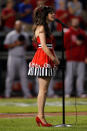 ARLINGTON, TX - OCTOBER 23: Zooey Deschanel sings the Star Spangled Banner prior toduring Game Four of the MLB World Series between the St. Louis Cardinals and the Texas Rangers at Rangers Ballpark in Arlington on October 23, 2011 in Arlington, Texas. (Photo by Tom Pennington/Getty Images)