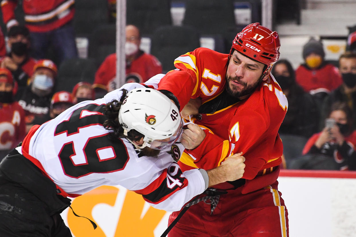 CALGARY, AB - JANUARY 13: Milan Lucic #17 of the Calgary Flames fights Scott Sabourin #49 of the Ottawa Senators during an NHL game at Scotiabank Saddledome on January 13, 2022 in Calgary, Alberta, Canada. (Photo by Derek Leung/Getty Images)