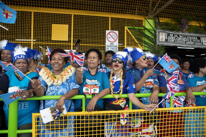 Local Fijian women wait for the arrival of Meghan, Duchess of Sussex at a market in Suva, Fiji, Wednesday, Oct. 24, 2018. Prince Harry and his wife Meghan are on day nine of their 16-day tour of Australia and the South Pacific. (Ian Vogler/Pool Photo via AP)
