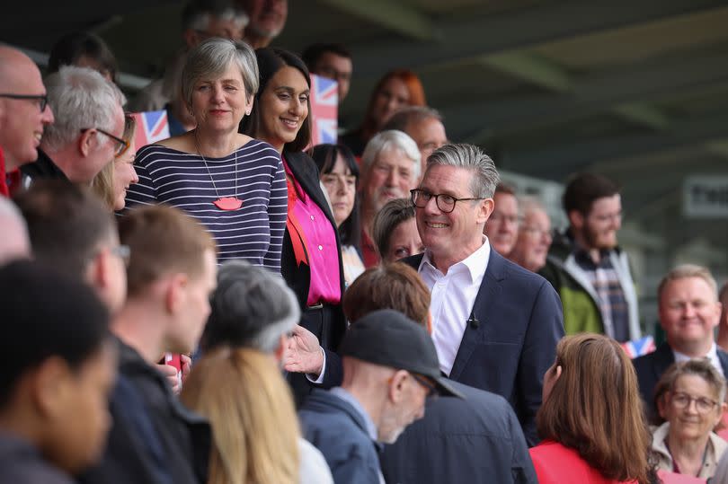 Sir Keir Starmer pictured during his visit to Hucknall Town Football Club, with Newark candidate Saj Ahmad pictured in a pink shirt just above him