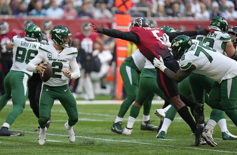 New York Jets quarterback Zach Wilson (2) takes the ball during an NFL football game between the New York Jets and the Atlanta Falcons at the Tottenham Hotspur stadium in London, England, Sunday, Oct. 10, 2021. (AP Photo/Alastair Grant)