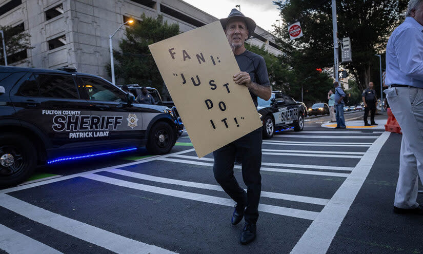 A demonstrator holds a sign in support of prosecutor Fani Willis outside of the Lewis R. Slaton Courthouse before this week’s indictment of former U.S. President Donald Trump in Atlanta, Georgia. (Christian Monterrosa/AFP)