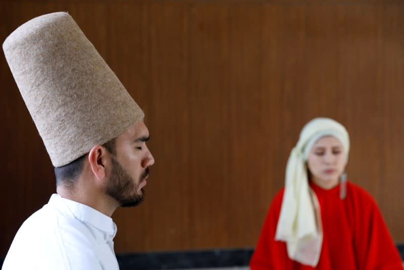 Mirzaie, founder of a Sama Dance group and her teammate meditate before dance in Kabul