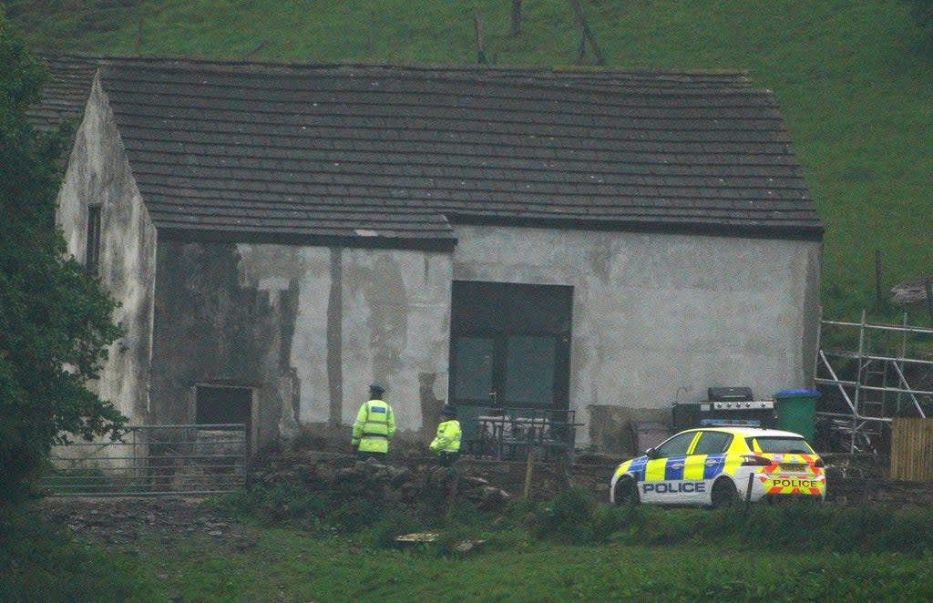 Police at a building in Milnrow, Rochdale after a three-year-old boy died after a suspected dog attack (PA)