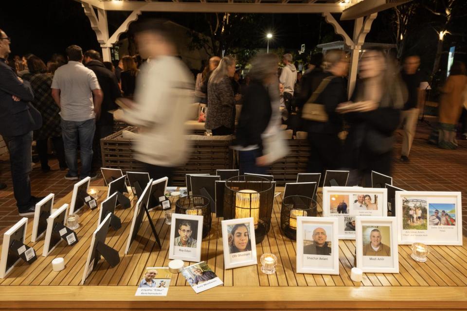 Small framed pictures are displayed on a wooden table.